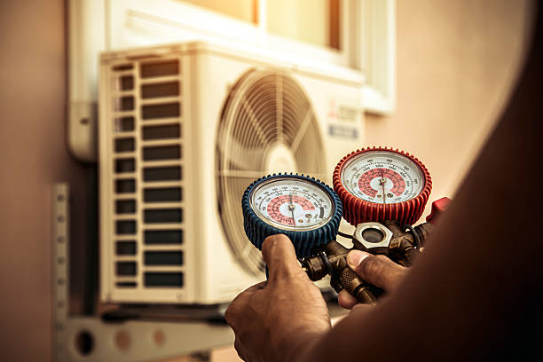 Professional Air Conditioning Service technician working in Ellington, MO